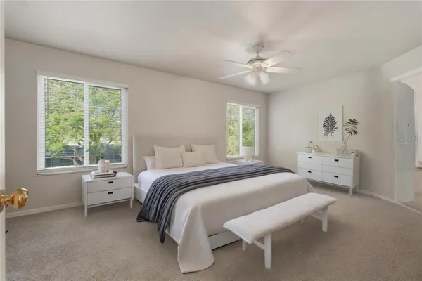 a view of an empty room with a chandelier fan
