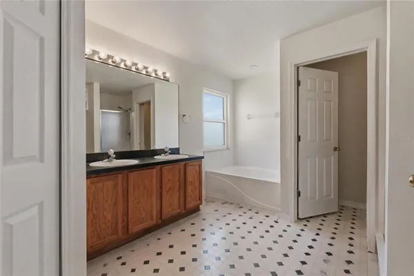 a view of a room that has a window and a wooden floor