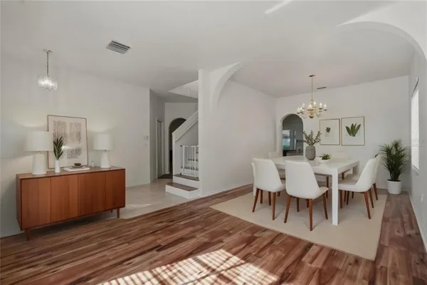 a view of empty room with window and ceiling fan