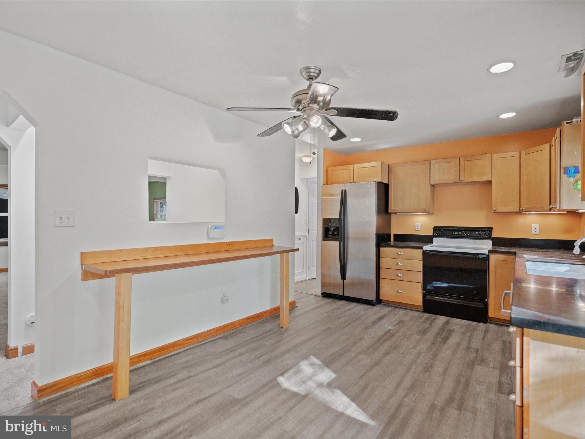3671 Dory Brooks Road Chesapeake Beach, MD 20732 - Photo 15 of 36 a kitchen with stainless steel appliances a refrigerator and a stove top oven