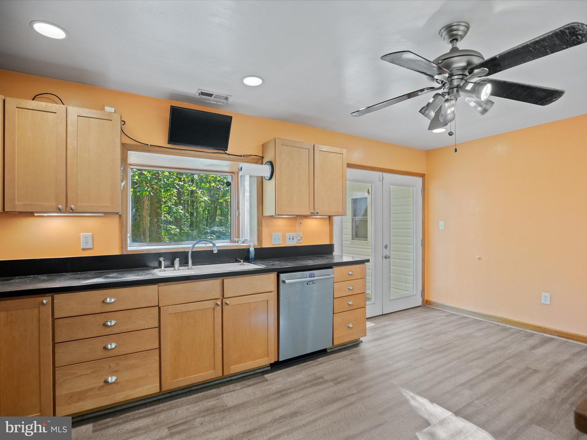 3671 Dory Brooks Road Chesapeake Beach, MD 20732 - Photo 16 of 36 a kitchen with granite countertop a stove a sink and a refrigerator with wooden floors