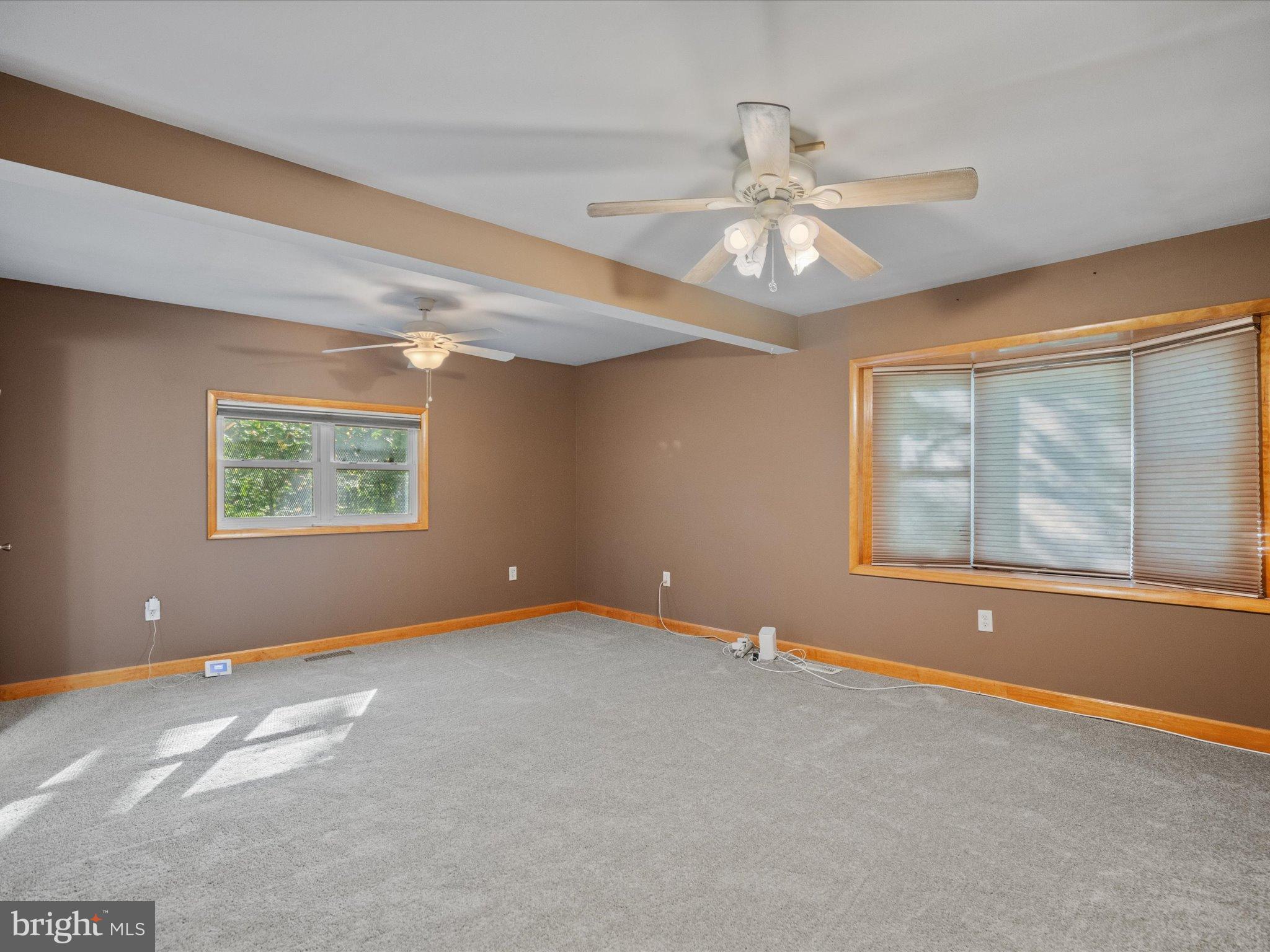 3671 Dory Brooks Road Chesapeake Beach, MD 20732 - Photo 24 of 36 an empty room with windows and fan