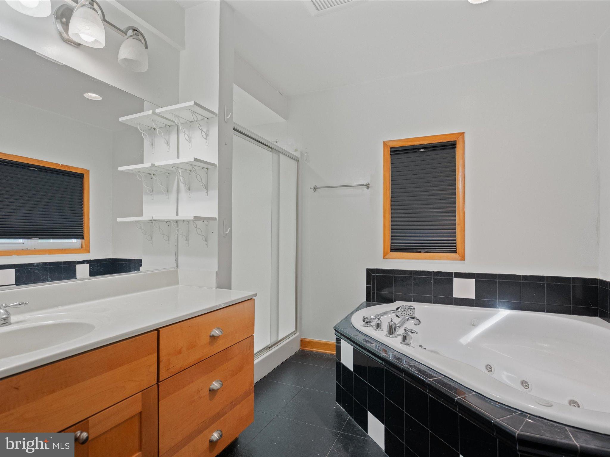 3671 Dory Brooks Road Chesapeake Beach, MD 20732 - Photo 27 of 36 a bathroom with a bathtub and a sink