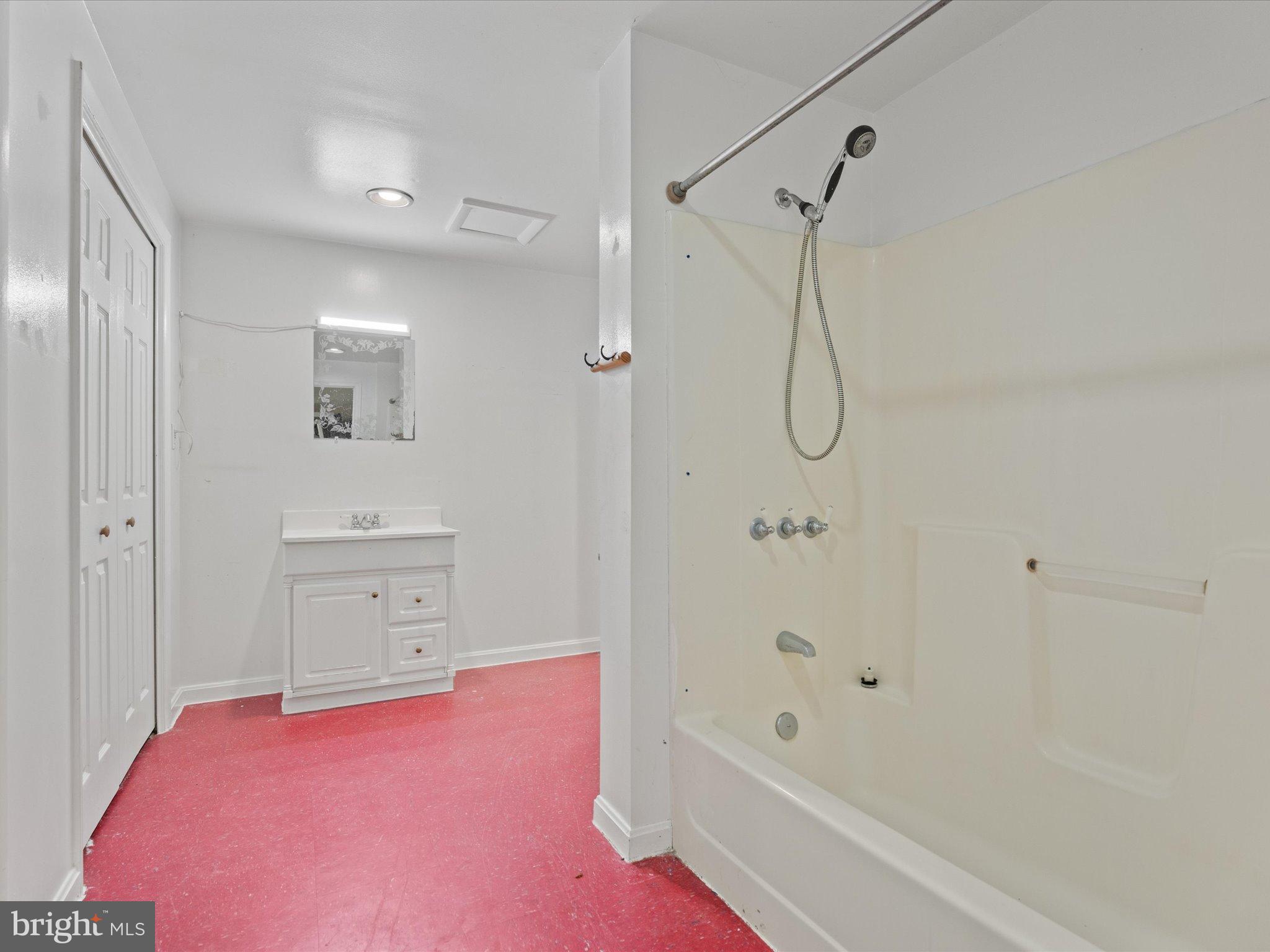 3671 Dory Brooks Road Chesapeake Beach, MD 20732 - Photo 31 of 36 a bathroom with a bathtub shower sink and toilet