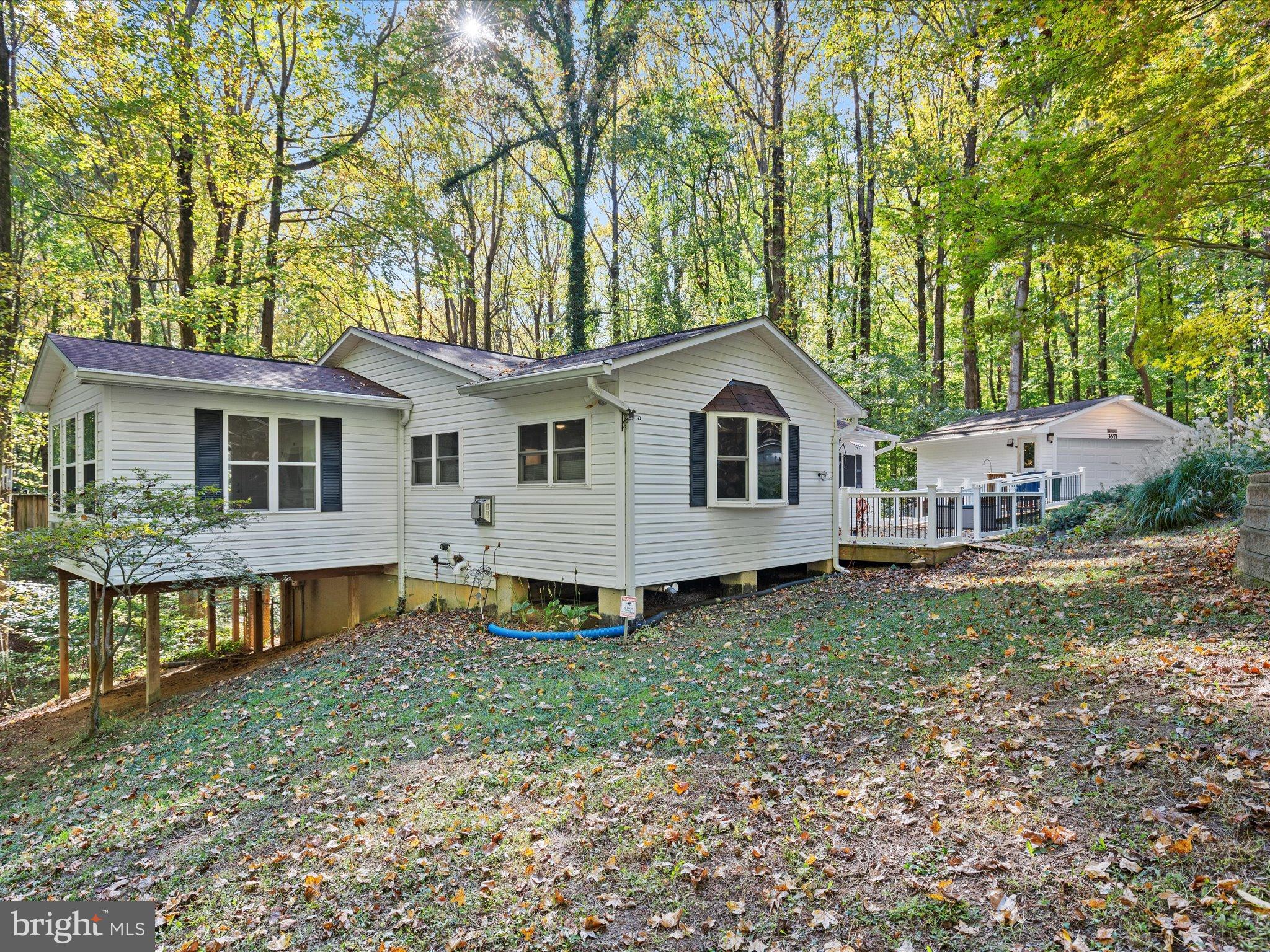 3671 Dory Brooks Road Chesapeake Beach, MD 20732 - Photo 6 of 36 a front view of a house with garden