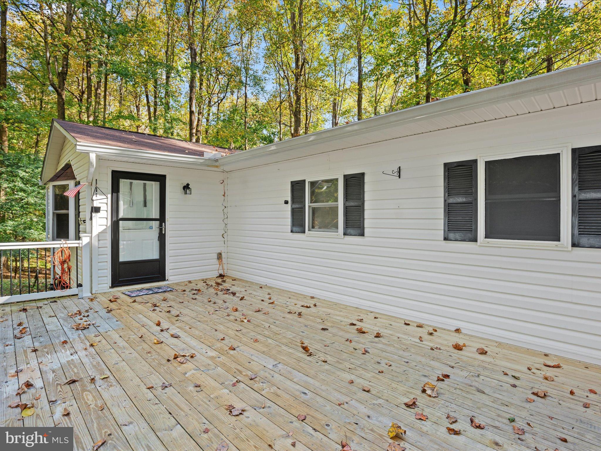 3671 Dory Brooks Road Chesapeake Beach, MD 20732 - Photo 9 of 36 a house with trees in front of it