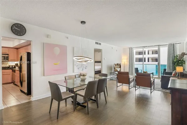 a view of a dining room with furniture window and wooden floor
