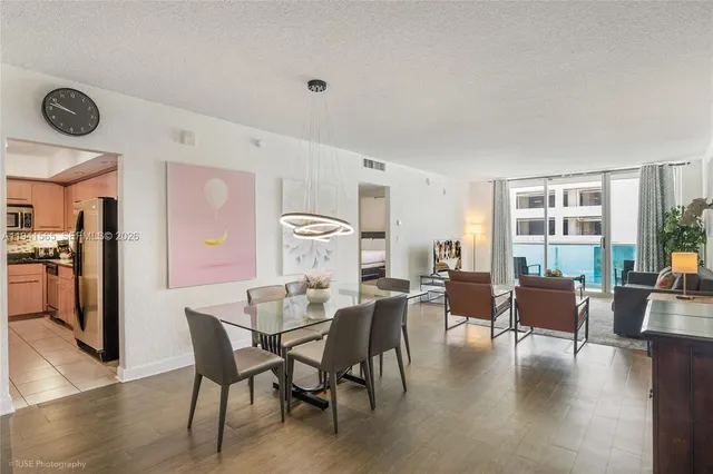 a view of a dining room with furniture window and wooden floor