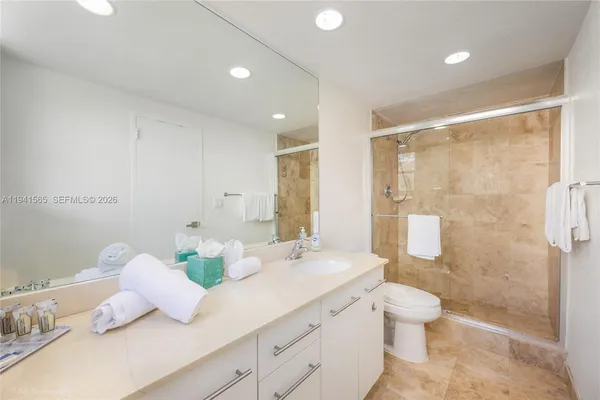 a bathroom with a double vanity sink toilet and shower