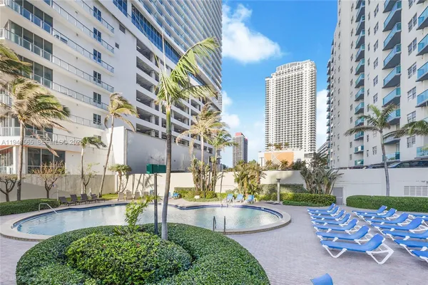 a swimming pool with outdoor seating and yard