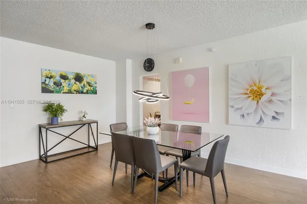 a view of a dining room with furniture and wooden floor
