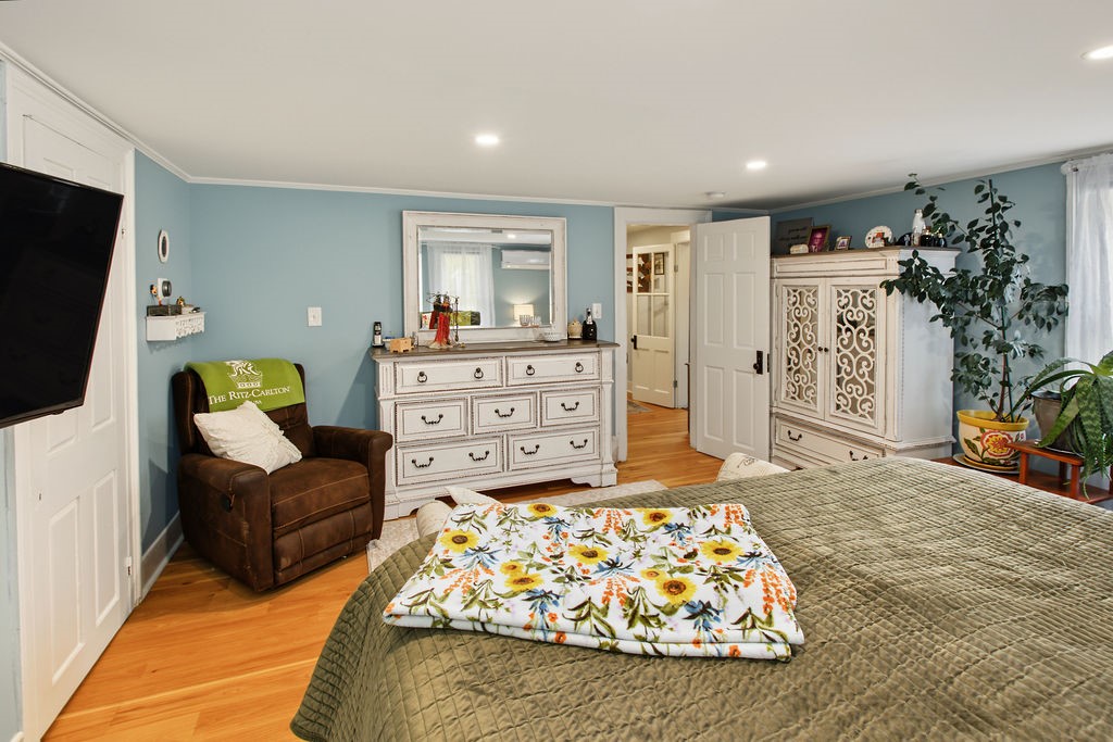 1668 Vandervort Hill Road Unadilla, NY 13849 - Photo 18 of 50 Gleaming hardwood floors and recessed lighting anchor this comfortable primary bedroom suite.