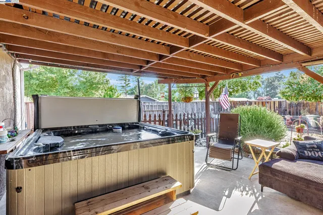 a view of patio with table and chairs under an umbrella