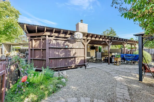 a view of a house with a yard and sitting area