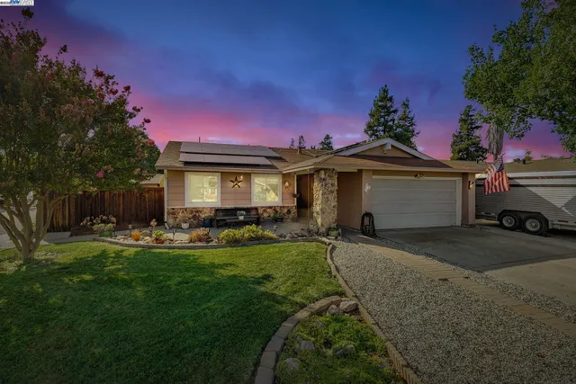 a front view of a house with a garden and porch