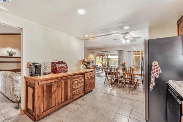 a kitchen that has a lot of cabinets a sink and wooden floor
