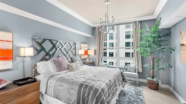 a bedroom with a bed couch and potted plant