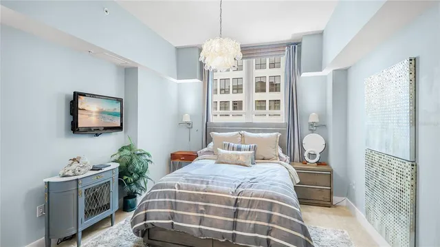 a bedroom with a bed and a flat screen tv