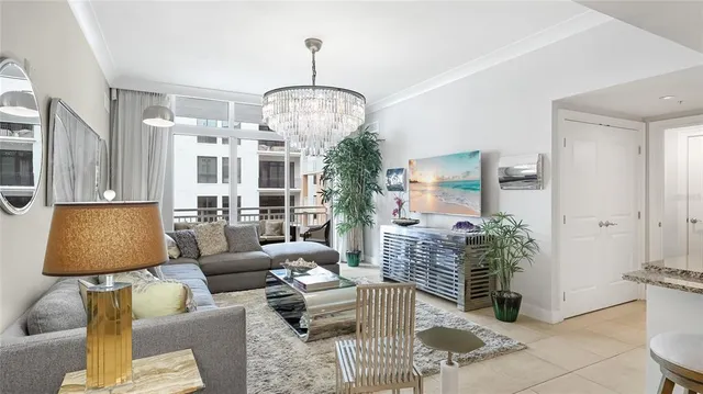 a living room with furniture a chandelier and a chandelier