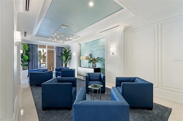 an aerial view of ocean and residential houses with outdoor space