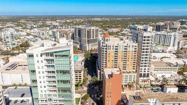 an aerial view of city and ocean