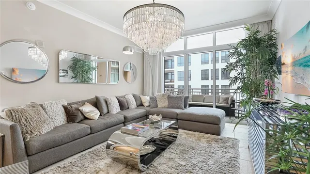 a living room with furniture and a chandelier