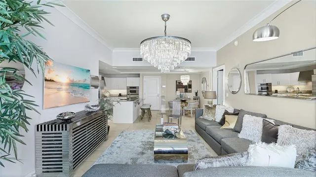 a living room with furniture and a chandelier