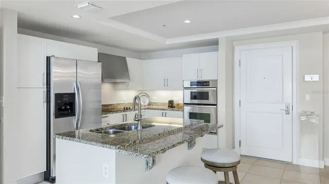 a kitchen with a sink and refrigerator