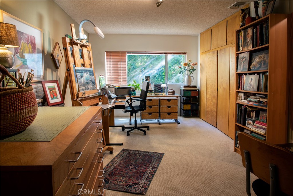 2700 Mill Creek Road Mentone, CA 92359 - Photo 7 of 22 a living room with furniture a bookshelf and a large window