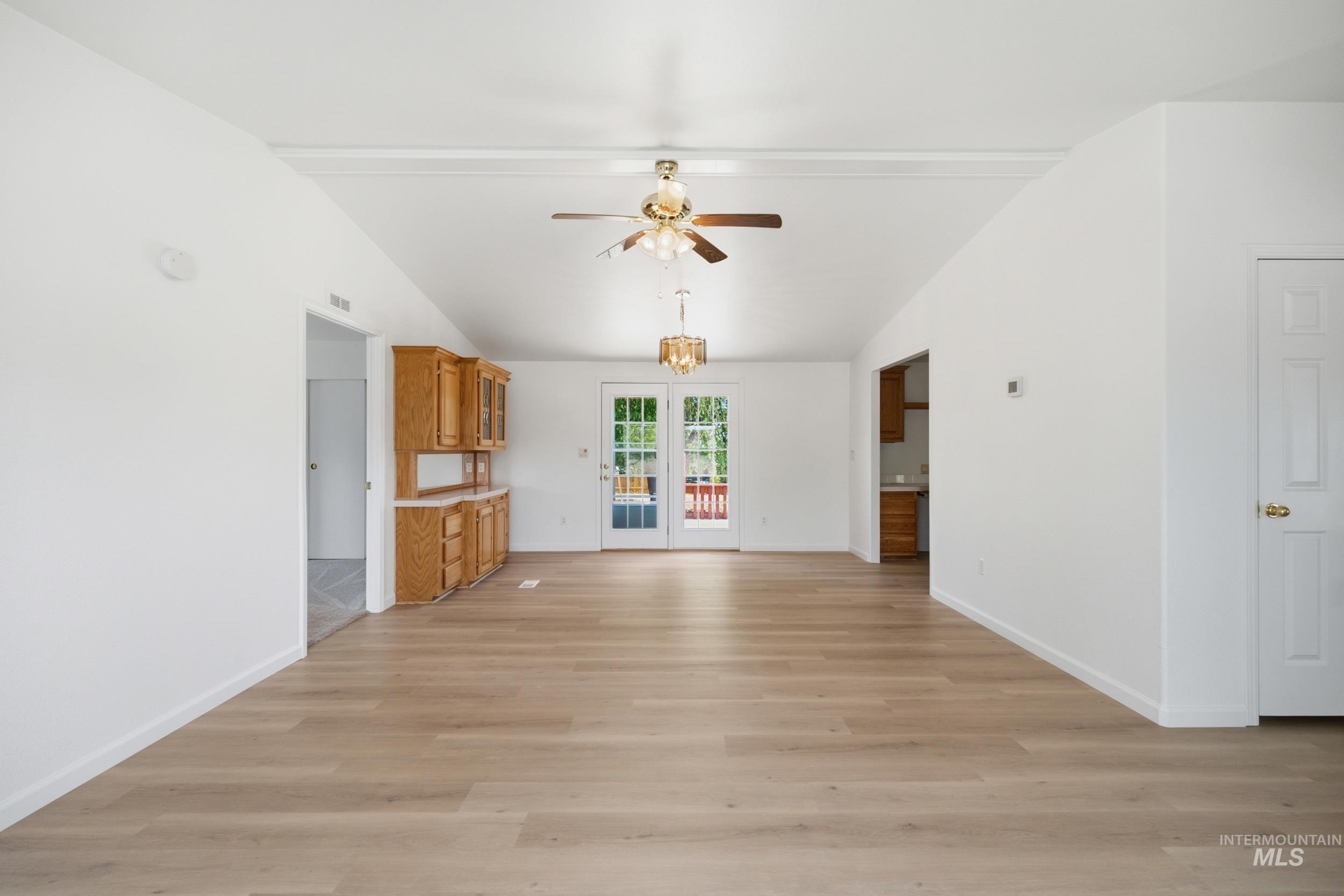 7422 Track Road Nampa, ID 83686 - Photo 15 of 50 Spacious central room featuring light wood-finish flooring, vaulted ceilings, and a ceiling fan