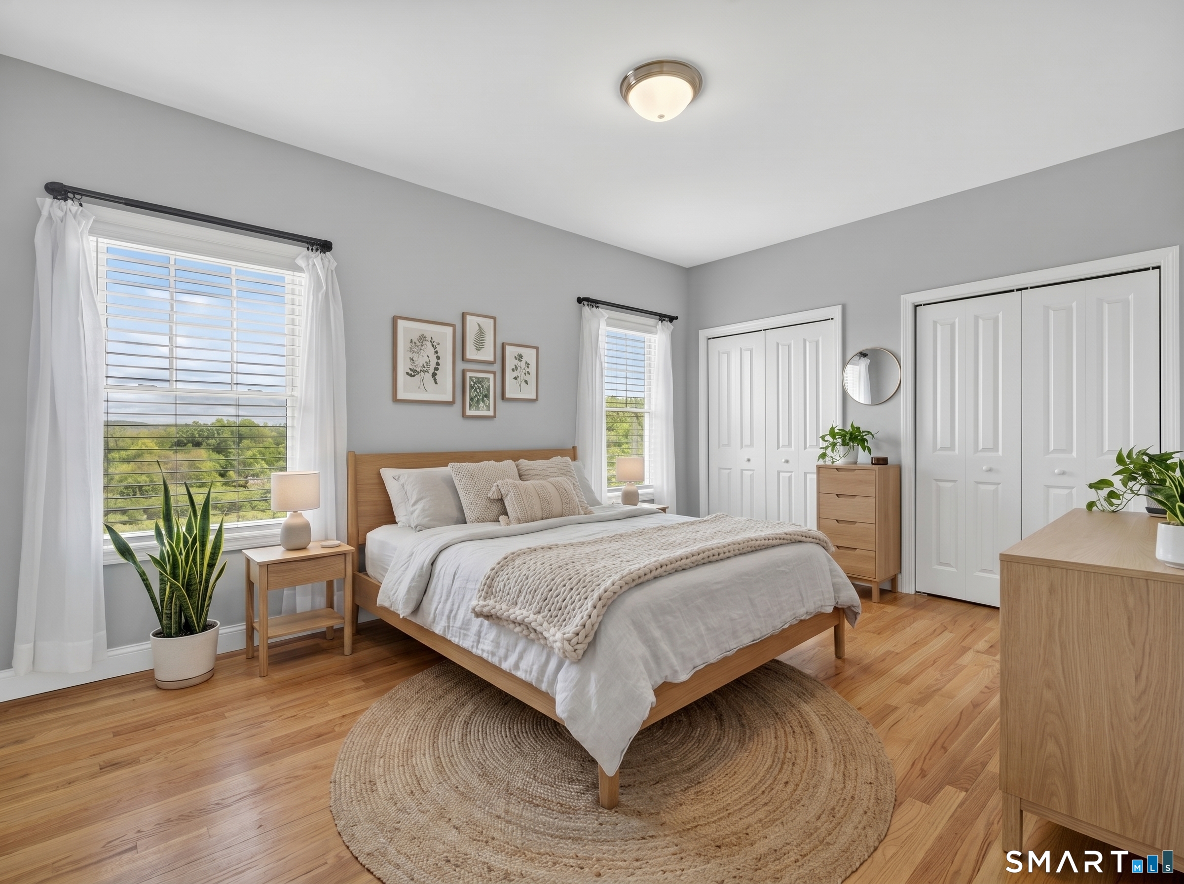 650 Ridgewood Road Middletown, CT 06457 - Photo 19 of 40 a bedroom with a large bed and a potted plant
