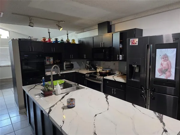 a kitchen with a refrigerator and a stove