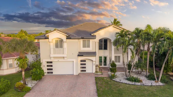 a front view of a house with a yard and garage