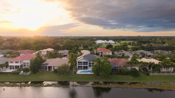 an aerial view of residential houses with outdoor space and river