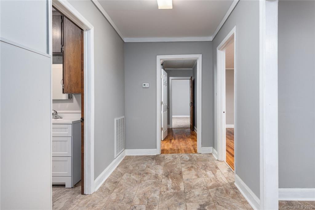 113 Steakhouse Road Morganton, NC 28655 - Photo 8 of 19 a view of a hallway with wooden floor and a bathroom