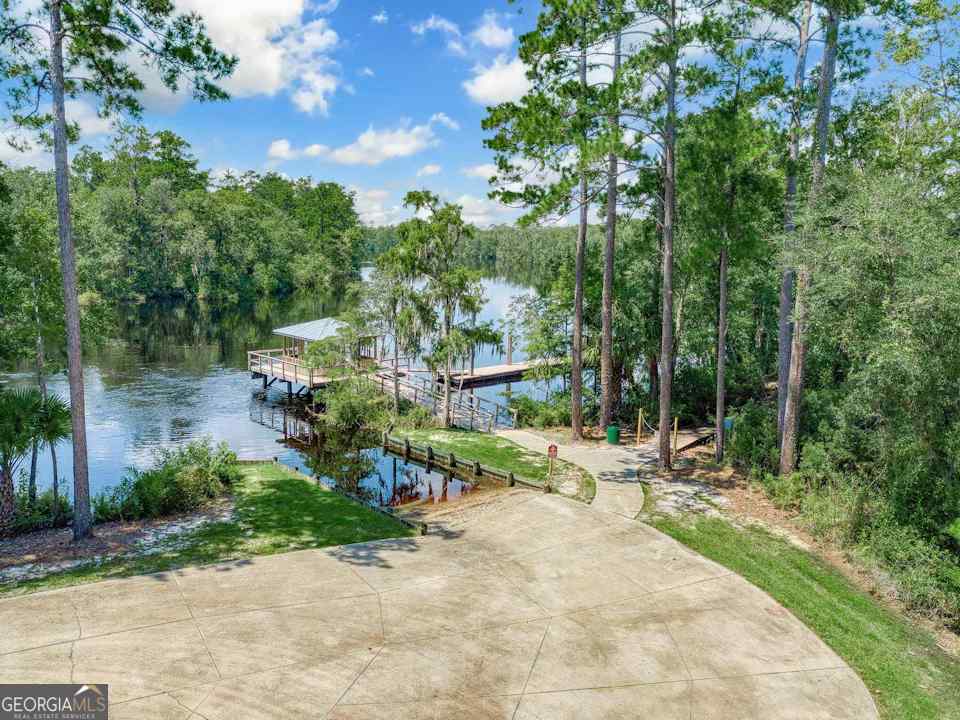236 Park View Lane Kingsland, GA 31548 - Photo 11 of 17 a view of backyard with a table and chairs and potted plants