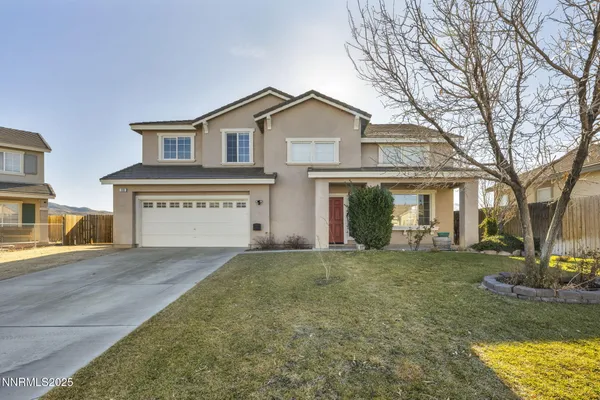 a view of a house with a yard and garage