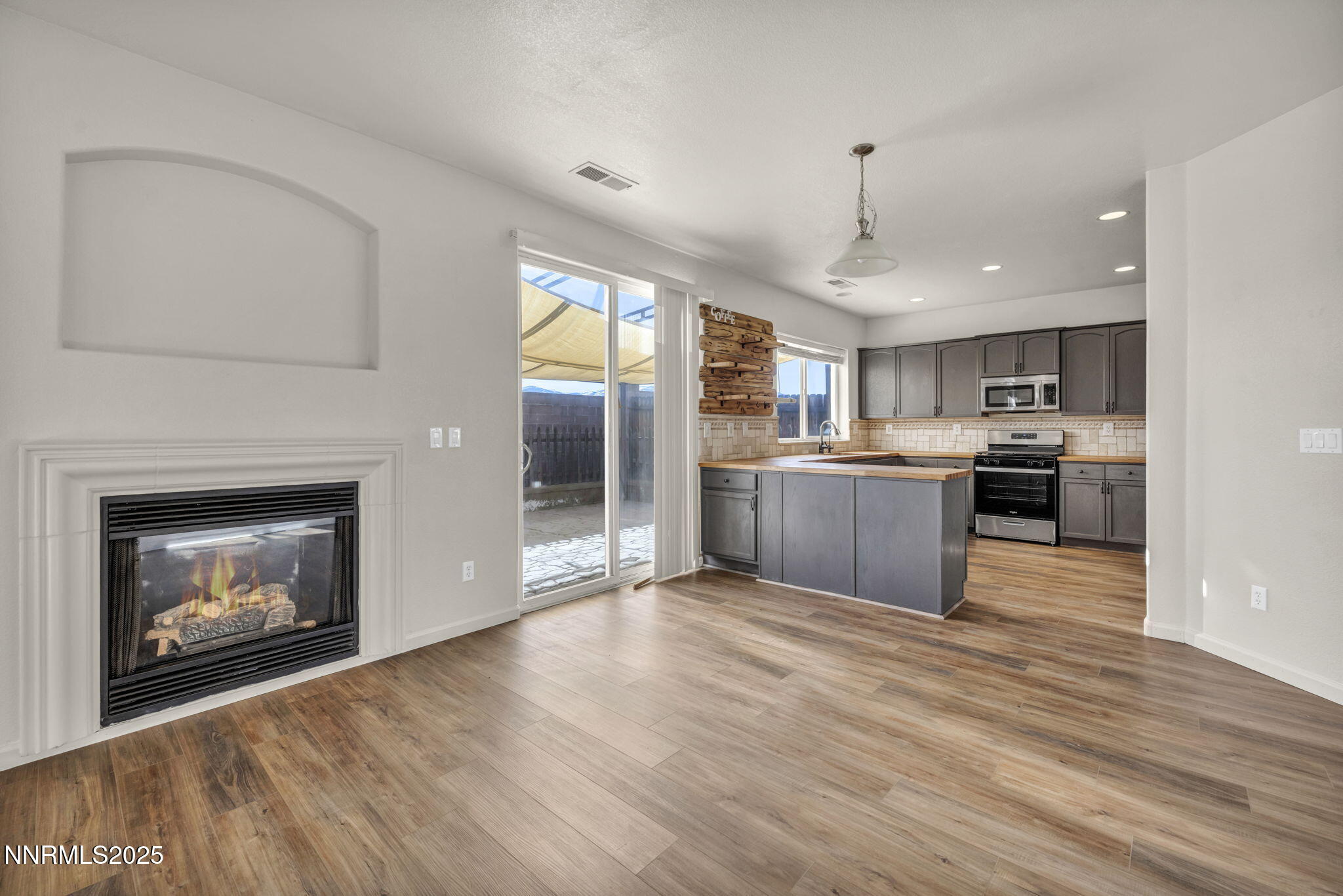 119 Red Oak Court Fernley, NV 89408 - Photo 11 of 64 a view of kitchen with granite countertop cabinets and wooden floor