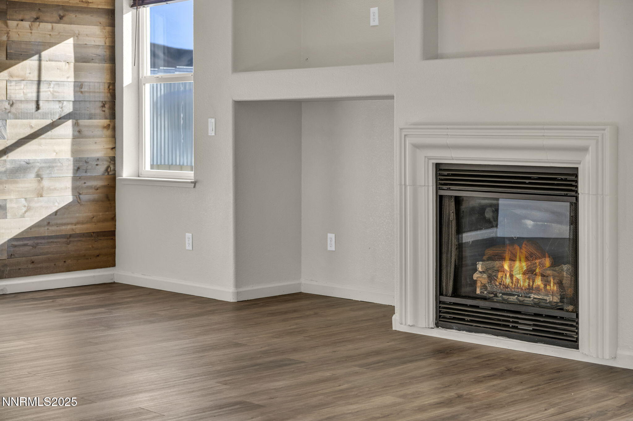 119 Red Oak Court Fernley, NV 89408 - Photo 12 of 64 a view of an empty room with wooden floor fire place and windows