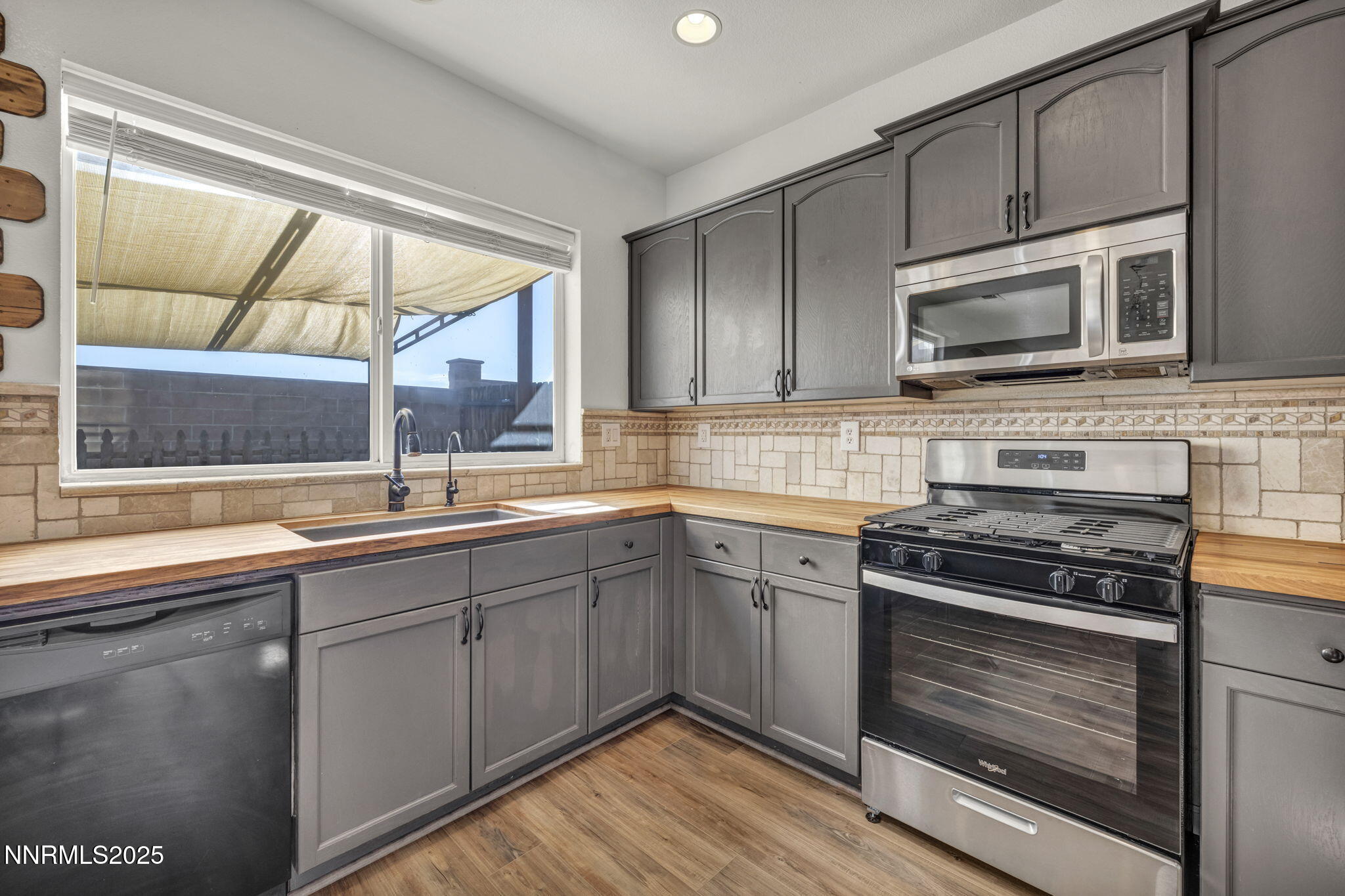 119 Red Oak Court Fernley, NV 89408 - Photo 16 of 64 a kitchen with stainless steel appliances a stove sink and microwave