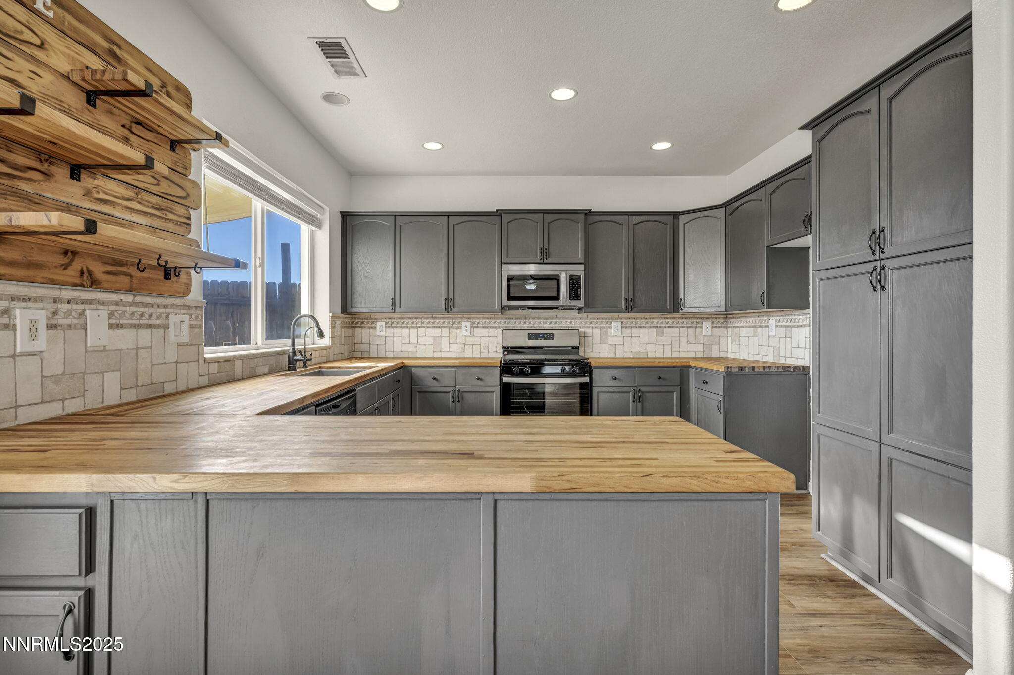 119 Red Oak Court Fernley, NV 89408 - Photo 17 of 64 a kitchen with stainless steel appliances granite countertop a sink refrigerator and cabinets