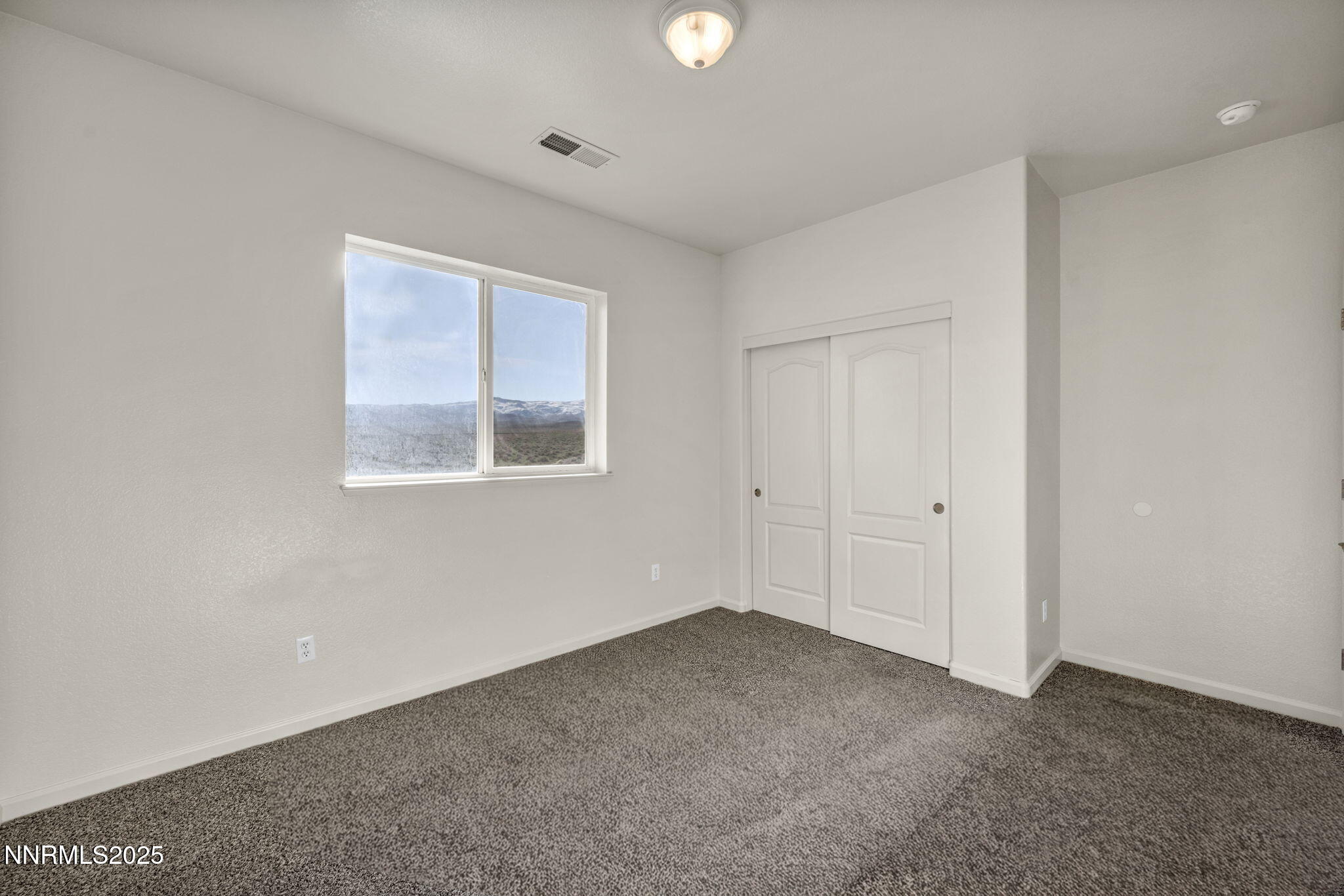 119 Red Oak Court Fernley, NV 89408 - Photo 31 of 64 a view of an empty room with a window