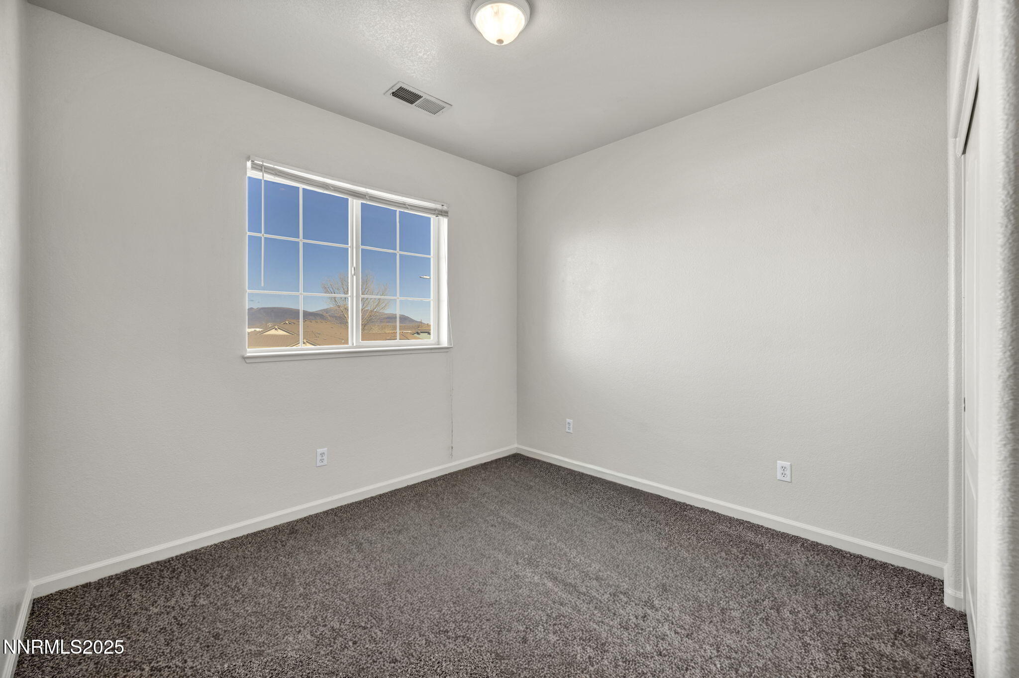 119 Red Oak Court Fernley, NV 89408 - Photo 33 of 64 an empty room with a window