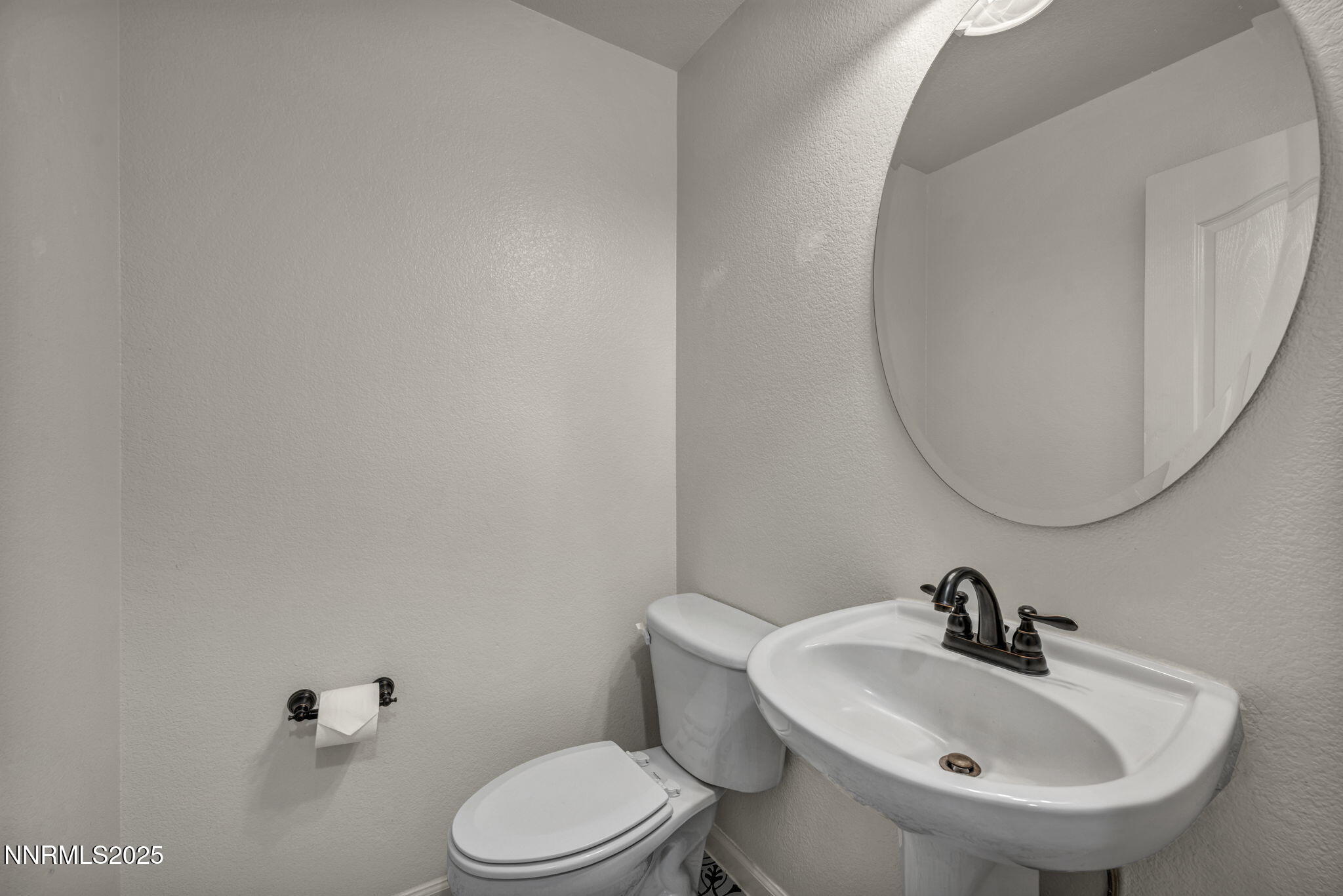 119 Red Oak Court Fernley, NV 89408 - Photo 39 of 64 a bathroom with a sink a mirror and a toilet