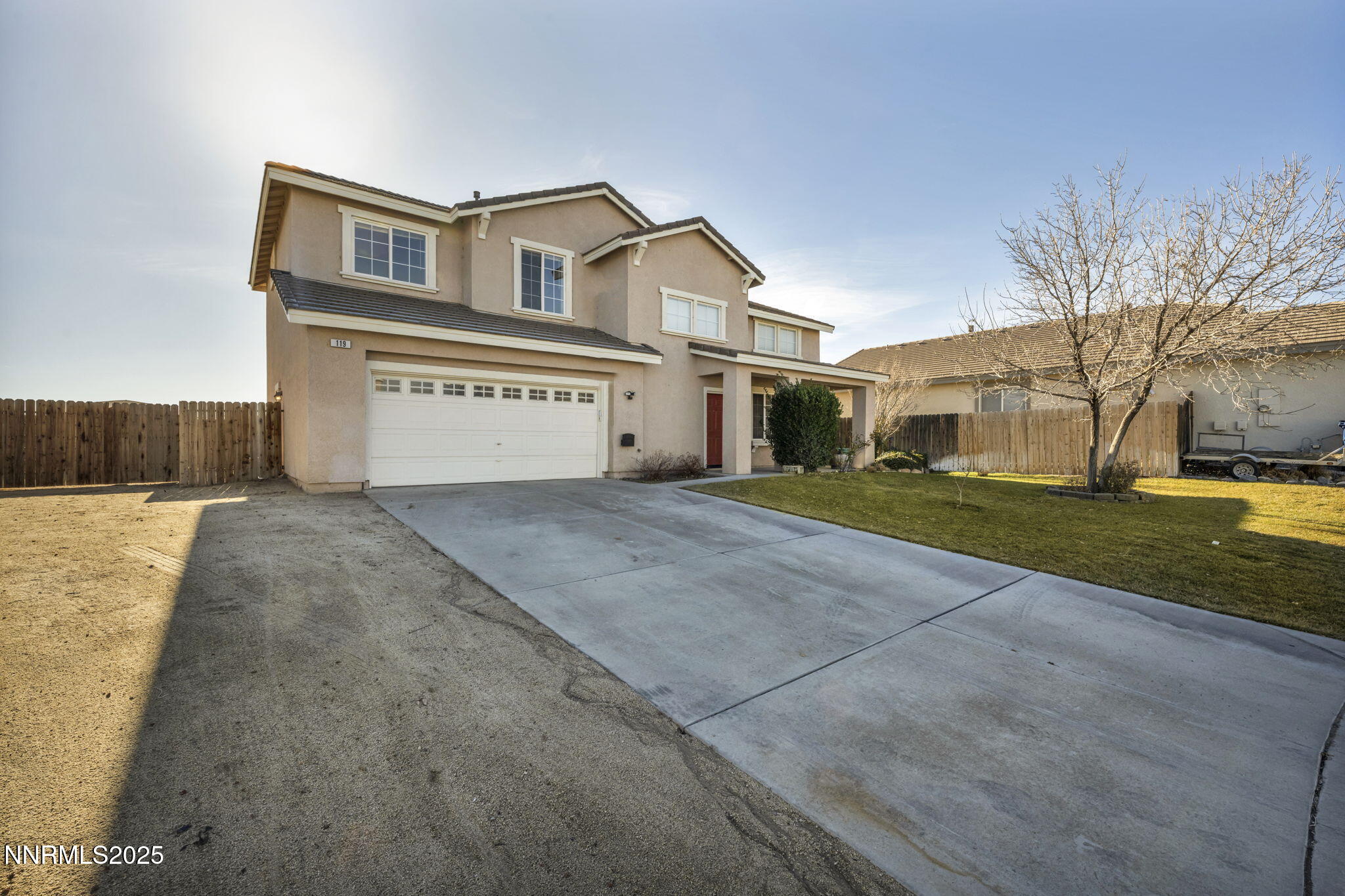 119 Red Oak Court Fernley, NV 89408 - Photo 4 of 64 a front view of a house with a yard and garage
