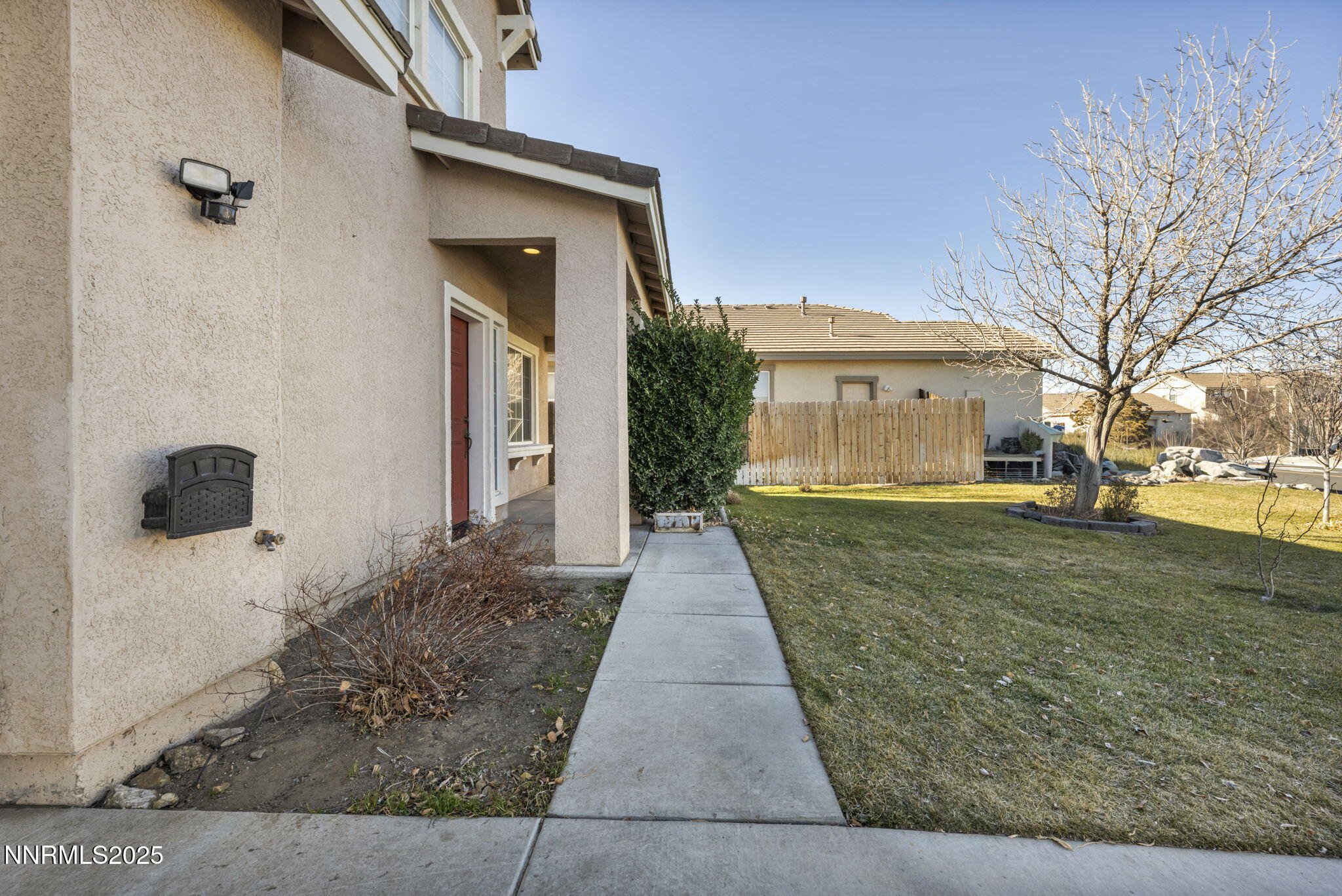 119 Red Oak Court Fernley, NV 89408 - Photo 48 of 64 a view of a white house with a yard