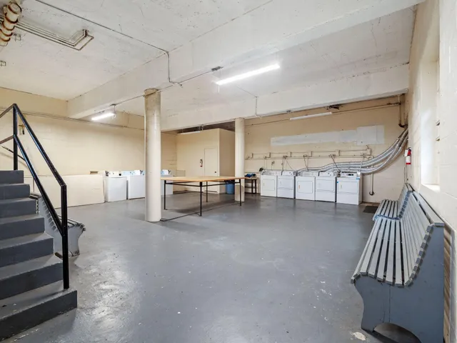 a view of a livingroom with furniture and stairs