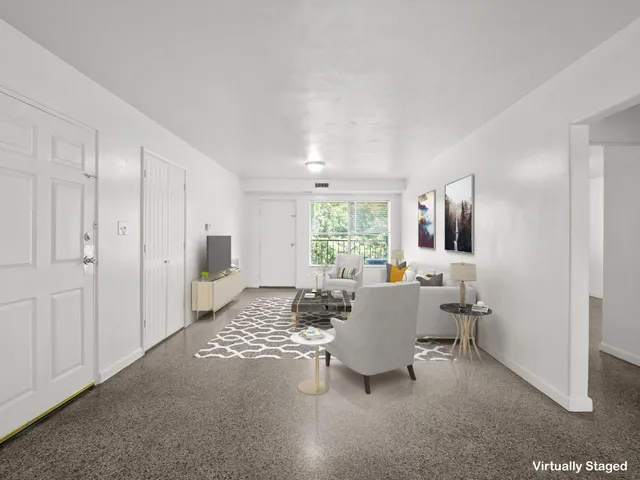 a living room with furniture and a large window