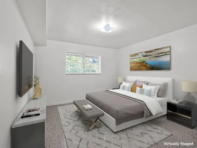 a bedroom with a bed and a flat screen tv