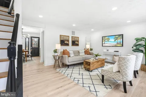 a living room with furniture wooden floor and a flat screen tv